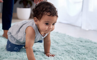 Baby crawling confidently in a home treated with non-toxic pest control.